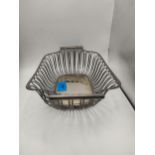A silver wire woven rectangular basket with opposing handles, bears indistinct hallmarks,