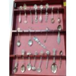 A Modern spoon display wall cabinet and contents to include Chinese white metal teaspoons and silver