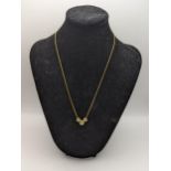 A 9ct gold necklace having a three 9ct gold and diamond pendants, total weight 4.0g Location: