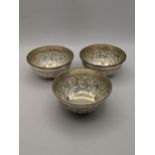 Three silver bowls, stamped silver to the bottom having an embossed engraved decoration total weight