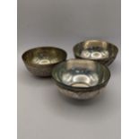 Three white metal bowls two having engraved detail of a figure and animal and one other, total