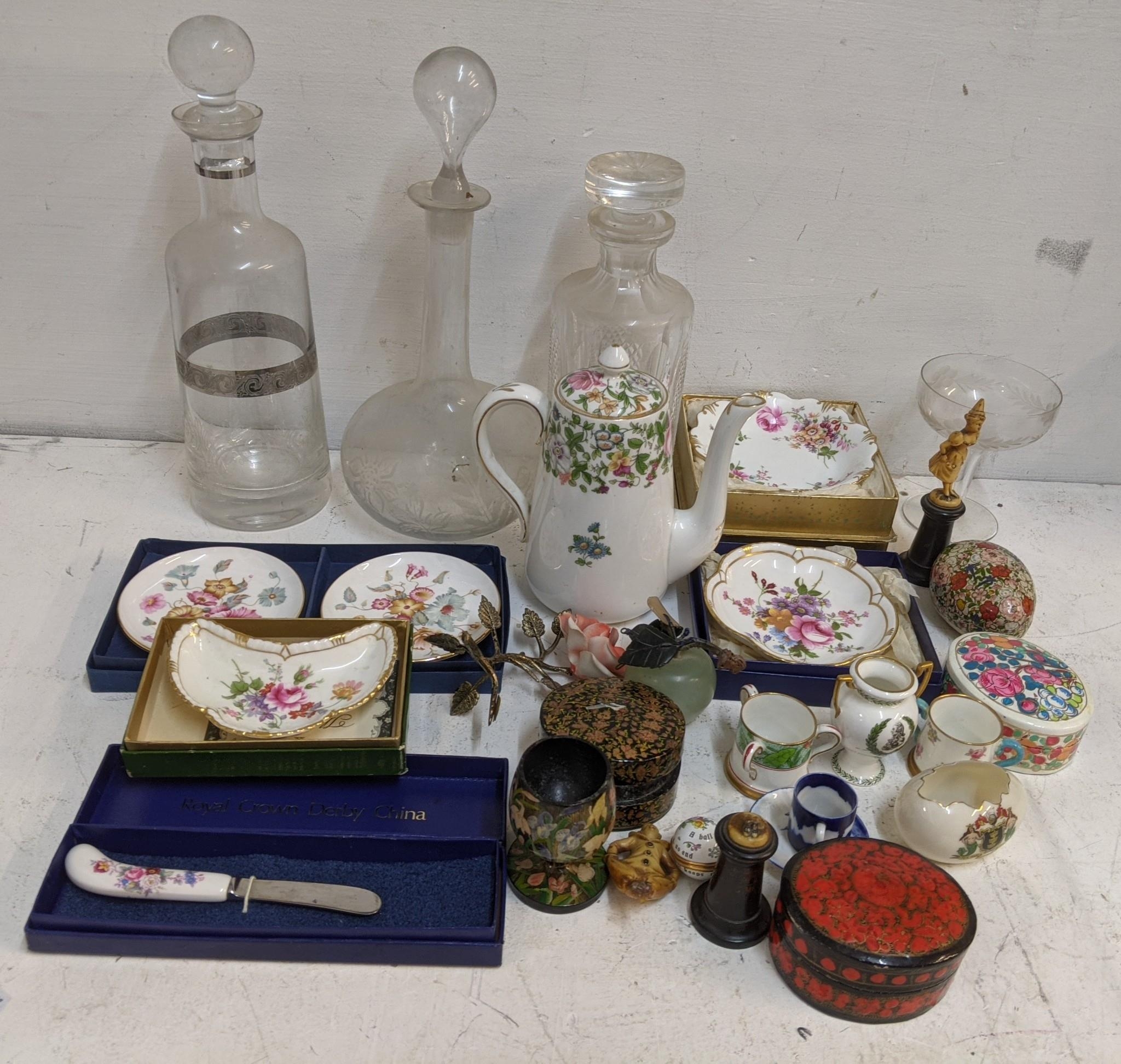 A mixed lot to include a boxed Royal Crown Derby, cut glass decanters, papiermache trinket boxes and