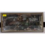 A model garage scene in a glazed case depicting a Norton truck surrounded by tools and equipment