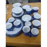A Denby blue part dinner service to include dinner and side plates, desert bowls, a milk jug,