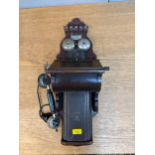 An L M Ericsson MFG Co Ltd mahogany finished cased wall mounted telephone Location: