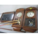 Two 8 day wall hanging clocks together with a display table top cabinet and three walking sticks,