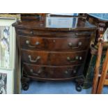 A mid 20th century mahogany bow fronted small chest of three long drawers and a brush slide. 70.5x