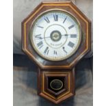 A vintage American Wall Clock by Seth Thomas having a white enamel dial with Roman numerals, in a
