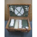 A vintage wicker picnic basket and contents Location: