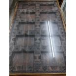 A Large Asian carved wooden door panel coffee table, the carved door panel ornately worked, with