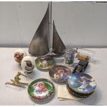 A mixed lot to include a metal sailing boat, two tribal eggs, a brass figurine, collector's plates