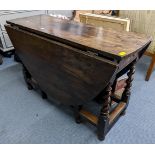 An early 18th century gateleg table, possibly elm wood and having single drawer, two fall flaps