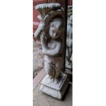 A reconstituted stoneware garden statue of a cherub holding a cornucopia, 82cm h Location: