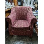 A Victorian upholstered tub style armchair, bun turned front legs, on castors, the red fabric with