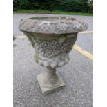 A reconstituted stoneware garden planter having a floral design and on square base Location: