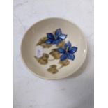 A Moorcroft dish decorated with blue flowers, 11dcm dia Location: