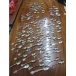 A quantity of sterling and 800 stamped silver and enamelled souvenir spoons, and silver plated