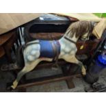 Early 20th painted wooden rocking horse on wooden safety base as a dapple grey with leather bridle