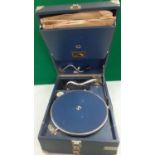 A vintage His Masters Voice Model 101 gramophone in a blue case together with a small quantity of