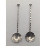 A pair of silver spoons made from silver coins of the Kingdom of England, a James II shilling and