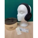 Ugg- A pair of black dyed shearling sheepskin earmuffs with leather trim. Location:R2.2