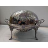A Sheffield plate breakfast/warming dish having embossed decoration and on four splayed legs, 23cm h
