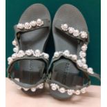 A pair of modern Arizona Love flip flop style sandals in fern green with embellished faux pearl