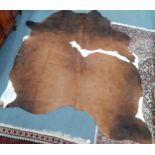 A brown and white cow hide, 197cm x 169cm approximately. Location:RAB Condition;Good, clean