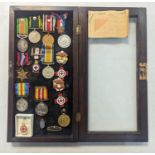 A display case A/F containing mixed medals, WWI British war and Victory medal, WWII British