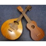 A late 19th Century mandolin, string A/F with case A/F together with a child's Japanese guitar.