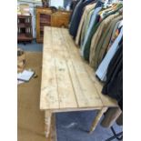 A Victorian pine kitchen table on turned legs with a planked top 242cm x 76cm x 73cm h Location: