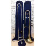 A cased Blessing Scholastic gold tone trombone A/F. Location:RWF Condition: Areas of scratches and
