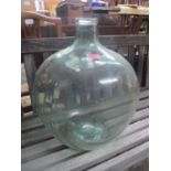 A green glass carboy Location: