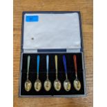 A cased set of six silver gilt spoons with enamelled handles, Birmingham 1964 Location: