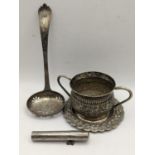 A Victorian silver strainer spoon, 48.1g together with an Indian white metal twin handled cup and