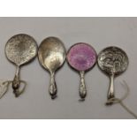 A selection of four late 19th/early 20th century miniature hand mirrors to include one with an