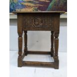 A 1930's carved oak stool with a hinged top, on turned block legs Location: