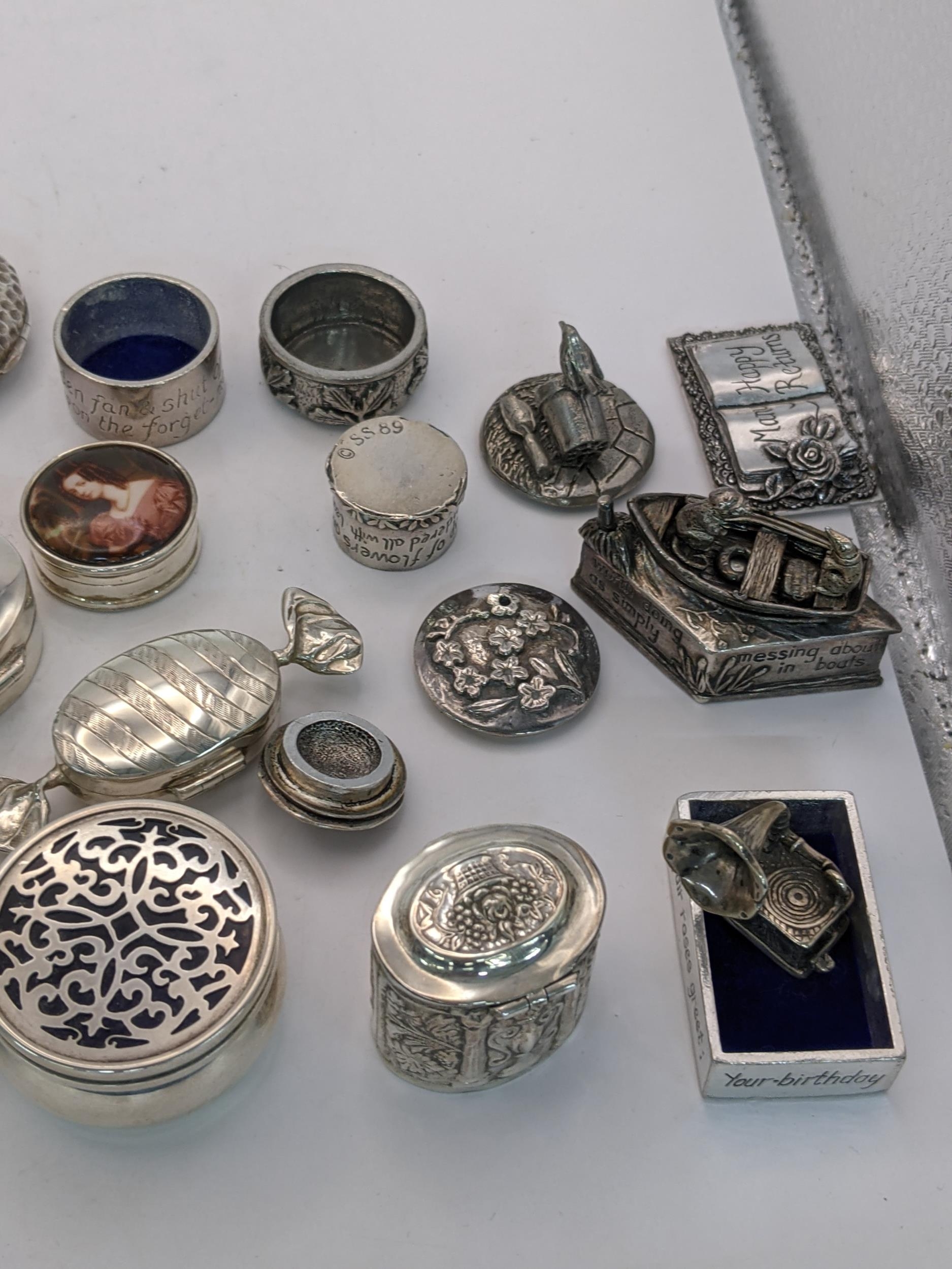 A collection of sterling silver and white metal pill boxes, also including a desk clock on an - Image 4 of 4