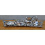 A sterling silver twin handled rectangular tray with a raised border and pierced decoration, a