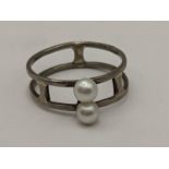 A pearl and white metal ring, the shank stamped 18ct, 3g Location: