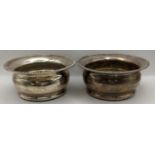 A pair of mid 20th century silver wine coasters, having gadrooned rim hallmarked Birmingham 1963