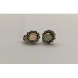 A pair of 18ct gold opal and diamond earrings stamped 750 having a gold earring backs, total