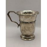 A 1930s silver christening mug engraved to the base, hallmarked Birmingham 1935, 93.9g Location: