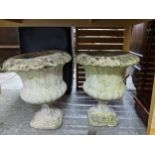 A pair of weathered garden concrete pedestal urns, 44cm high Location: