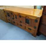 A Chinese elm low cabinet having five cupboard doors above four drawers, 61cm h x 134.5cm w