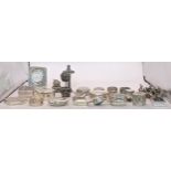 A collection of sterling silver and white metal pill boxes, also including a desk clock on an