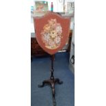 A late 19th mahogany shield backed and embroidered fire screen Location: BWR