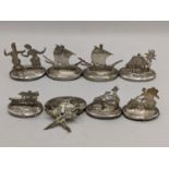 A set of eight white metal South East Asian place name/menu card holders Location: