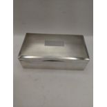 A silver cigarette box having engine turned design lid and wooden lining, hallmarked Birmingham 1974