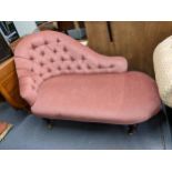 A reproduction Stuart Jones red button back upholstered chaise longue on stained beech legs and